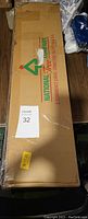 Box of the National Tree Company 3ft Pre-Lit Small Christmas Tree with clear lights, showing branding and packaging.