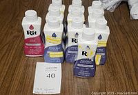 Photo of 11 bottles of Rit all-purpose dye showing color variety and new condition.