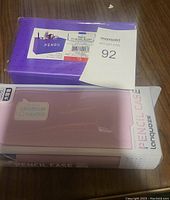 Photo of a purple pencil case holder and packaging of a pencil case for pegboards.