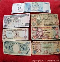 Front view of the first set of banknotes showing a Hong Kong 20 dollar note, UAE 5 dirhams, Japan 1000 yen, and Bank of Jamaica notes including 2, 5, 20 dollars