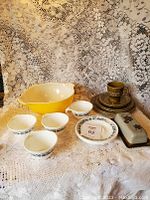 Photo showing the entire dishware set including yellow Pyrex bowl, Corelle white bowls and plates with black floral pattern, Beswick tea set with cups, saucers, and plates, and ceramic covered butter dish.