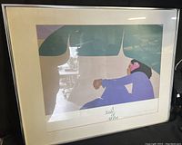 Full view of framed poster print "A Taste of Aloha" showing stylized person under banana leaf artwork with frame visible.