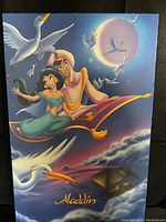 Full view of Disney Aladdin Colorplak wall art showing Aladdin and Jasmine on magic carpet with birds and pyramids at night.