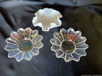 Three vintage dishes displayed on black fabric background: two clear iridescent carnival glass dishes and one white milk glass hobnail dish.