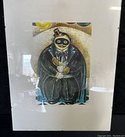 Full view of framed artwork showing the masked figure holding maracas