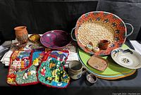 Full collection showing textiles, placemats, baskets, and pottery items arranged together