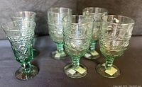 Group photo showing six vintage green glass goblets including Mikasa Garden Harvest and Studio Nova Adirondack wine glasses