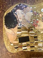 Close-up of the couple's faces and upper body in the print showing detailed patterns and colors in the mosaic robe.