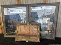 Overview of two large square mirrors with gray weathered wood frames and one smaller rectangular mirror with layered wood frame and metal corner accents.