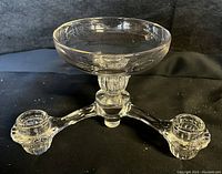 Three-quarter angled view of the vintage Cambridge Arms glass candelabra showing ribbed design and candle holders