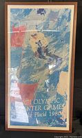 Full view of the framed colorful skier poster with text 'XIII Olympic Winter Games Lake Placid 1980'.