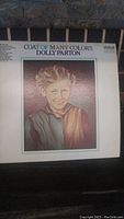 Front cover of Dolly Parton's "Coat of Many Colors" album showing the painted portrait of a young girl in a coat.