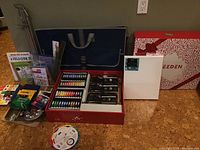 Overview of all art supplies arranged on floor
