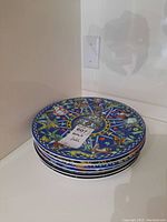 Stack of six BOPLA plates showing edges and labels
