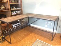 Full assembled L-shaped desk in room corner