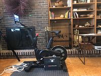 Full view of Echelon Connect exercise bike on floor mat with power adapter box in front