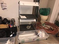 Overall view of grow light stand showing chrome frame, two trays and base