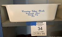 Corning Glass Works Family Day 1978 loaf pan showing blue printed text on one side.