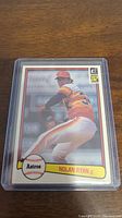 Front side of the 1982 Nolan Ryan Donruss baseball card showing Nolan Ryan pitching with Houston Astros in full uniform. Card is in plastic protective sleeve.