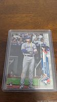 Front side of the Bo Bichette rookie card showing player in uniform, holding bat, labeled with rookie card symbol and team logo.