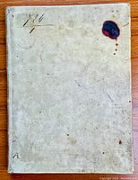 Front cover of the vellum parchment bound book with slight discoloration and a dark reddish stain in the upper right corner.