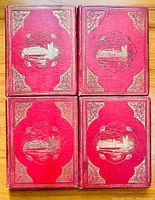 Four red cloth bound volumes with gilt embossed covers arranged in grid