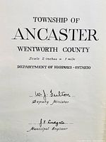 Close-up photo of the title and signatures block of the map showing 'Township of Ancaster, Wentworth County,' signed by W. J. Fulton (Deputy Minister) and J. V. Ludgate (Municipal Engineer).