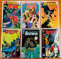 Photo of six Batman Detective Comics issues showing covers for issues #559, #563, #583, #591, #688, and Detective Annual #2