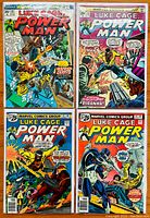 Photo of the four Luke Cage Power Man comic covers, issues #20, #30, #32, and #33 showing vibrant cover art and titles.