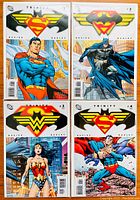 Four DC Comics Trinity series issues #1-4 front covers showing Superman, Batman, Wonder Woman, and Superman again with their iconic symbols.