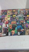 15 Gen 13 comic books arranged on a white surface, visible covers show a variety of characters and colorful artwork.