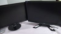 Two 22-inch computer monitors placed side by side on a surface, screens off, showing Acer and Asus brands.