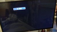 Front view of the LG 42" TV powered on with no signal message visible on screen.