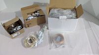 Overview of various new fairy lights in boxes and bubble wrap, including copper wire curtain lights and wrapped string lights.