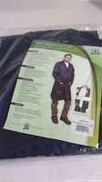 Blue shop coat in plastic packaging with product label showing a man wearing the coat and product details in English and French.