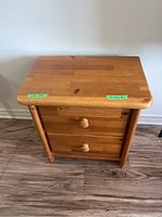 Top view of the solid wood side table showing the drawer knobs and wood grain.