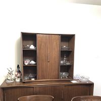 Front view of hutch showing center cabinet and open side shelving