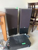 Pair of KEF floor-standing speakers and Yamaha receiver