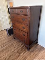 Angled full side and front view showing overall design, wood finish, and feet.