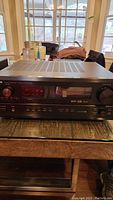 Front view of Denon AVR-3300 AV surround receiver showing control knobs, display screen, and power switch.