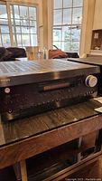 Front and side angled view of the Integra DTR-6.4 AV Receiver showing volume knob and front panel design.