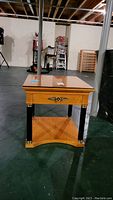 Full front view of the Thomasville end table showing top drawer, bottom shelf, decorative gold trim on dark legs.