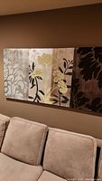 Full front view of the stretched canvas wall art mounted on wall above couch, shows overall piece and condition.