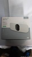 Original sealed box for Arlo Pro 3 Floodlight Camera showing product branding, key features like wired power, night vision, 2K video, HDR, smart siren, weather resistant