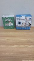 Photo of two boxed wireless baby monitors, Tequan and Kawa brands.