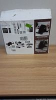 Photo of the exercise bike box showing product images and labels including arm exerciser and leg exerciser