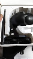 Black smart security camera with antenna in packaging
