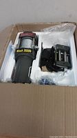 Winch puller in original packaging with foam inserts and accessories on the side.