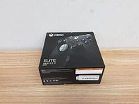 Original retail box of Xbox Elite Series 2 controller, showing front and top with branding and product image.