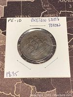 Front side of the 1835 token showing a three-masted ship in relief, mounted in protective holder with handwritten notes.